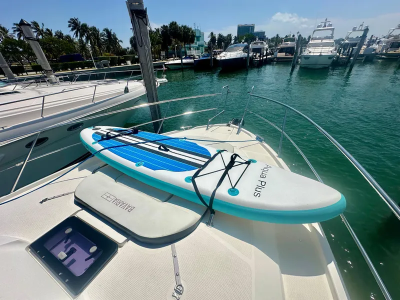 Slide: The Image of Bavaria Sport 360 HT 2016 yacht with paddleboard on deck, docked at marina. - 26