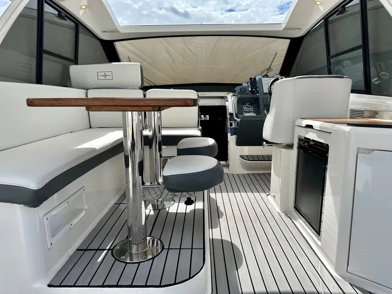 Slide: The Image of 2016 Bavaria Sport 360 HT interior with seating, table, and helm station. - 33