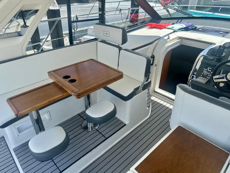 Slide: The Image of Interior of 2016 Bavaria Sport 360 HT yacht with seating and wooden table. - 34