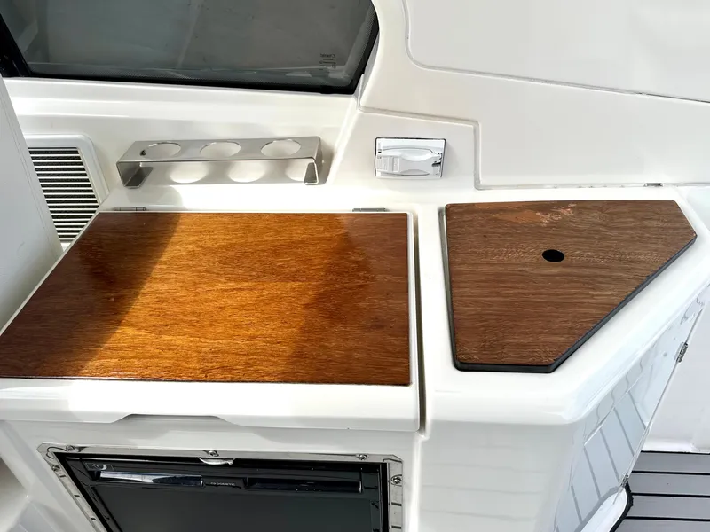 Slide: The Image of 2016 Bavaria Sport 360 HT yacht interior with wooden countertops and built-in storage. - 35