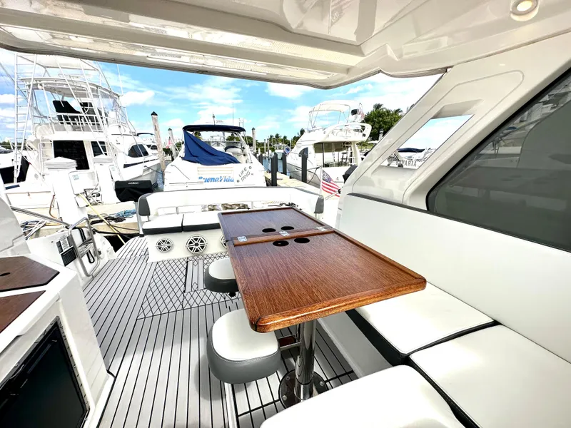 Slide: The Image of 2016 Bavaria Sport 360 HT yacht interior with wooden table and white seating. - 40