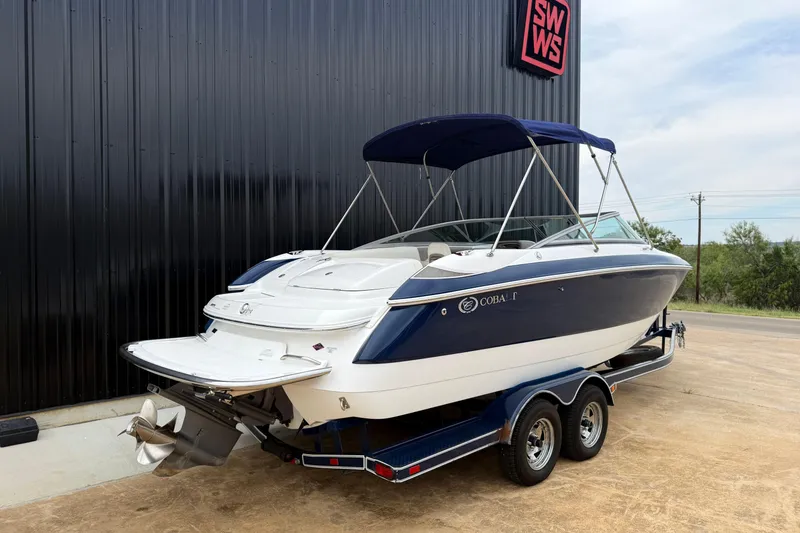 Slide: The Image of 2005 Cobalt 240 boat on trailer, parked outside a building with SWWS sign. - 13