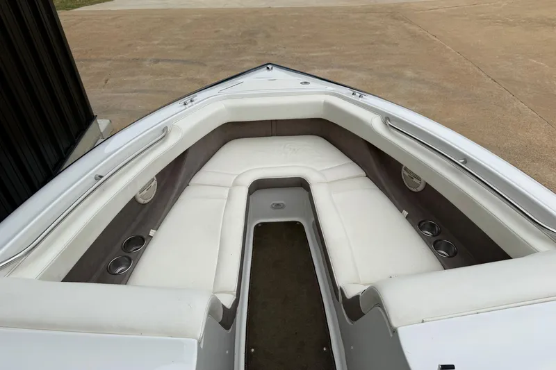 Slide: The Image of 2005 Cobalt 240 boat interior with white seating and cup holders. - 4