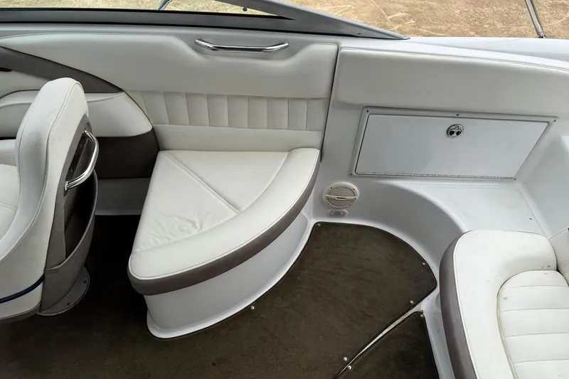Slide: The Image of Interior of a 2005 Cobalt 240 boat with white and gray seating. - 7