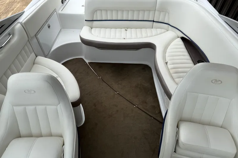 Slide: The Image of Interior of 2005 Cobalt 240 boat with white leather seating and brown carpet. - 8