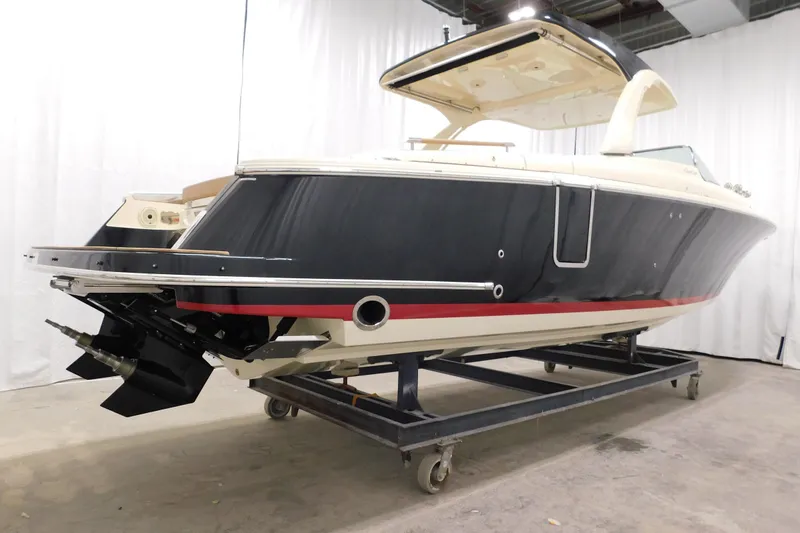 Slide: The Image of 2021 Chris-Craft Launch 35 GT boat in showroom, side view with sleek design. - 16