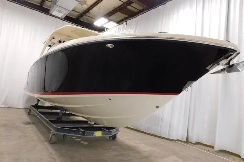 Slide: The Image of 2021 Chris-Craft Launch 35 GT boat in indoor storage, showcasing sleek design and craftsmanship. - 17