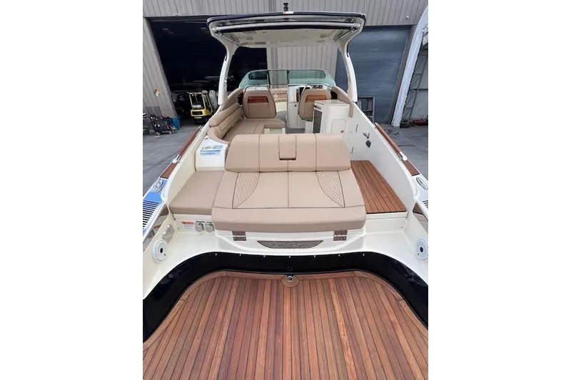 Slide: The Image of 2021 Chris-Craft Launch 35 GT boat interior with luxurious seating and wooden deck. - 24
