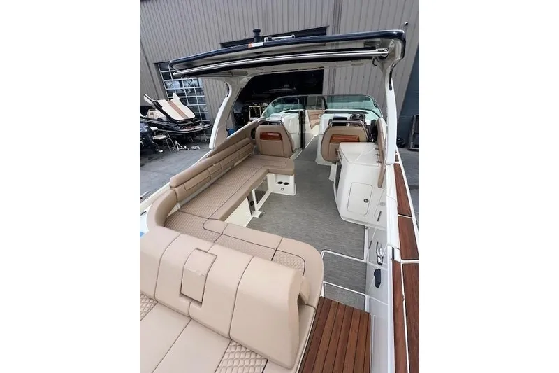 Slide: The Image of 2021 Chris-Craft Launch 35 GT boat interior with beige seating and wood accents. - 27