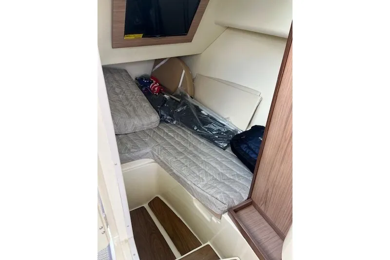 Slide: The Image of 2021 Chris-Craft Launch 35 GT cabin interior with bed and wooden accents. - 34