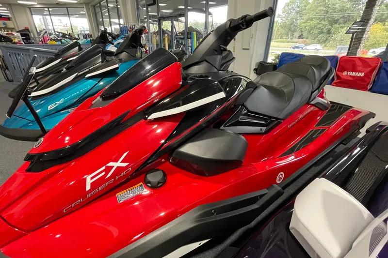 Slide: The Image of 2026 Yamaha WaveRunner FX Cruiser HO in showroom, vibrant red color, sleek design. - 2