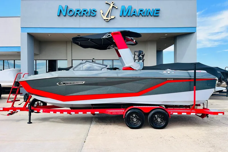 The Image of 2026 Nautique Super Air Nautique G25 boat on red trailer at Norris Marine dealership. - 2