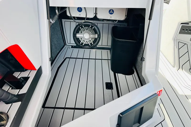 Slide: The Image of 2026 Nautique Super Air Nautique G25 interior with sleek flooring and sound system. - 36