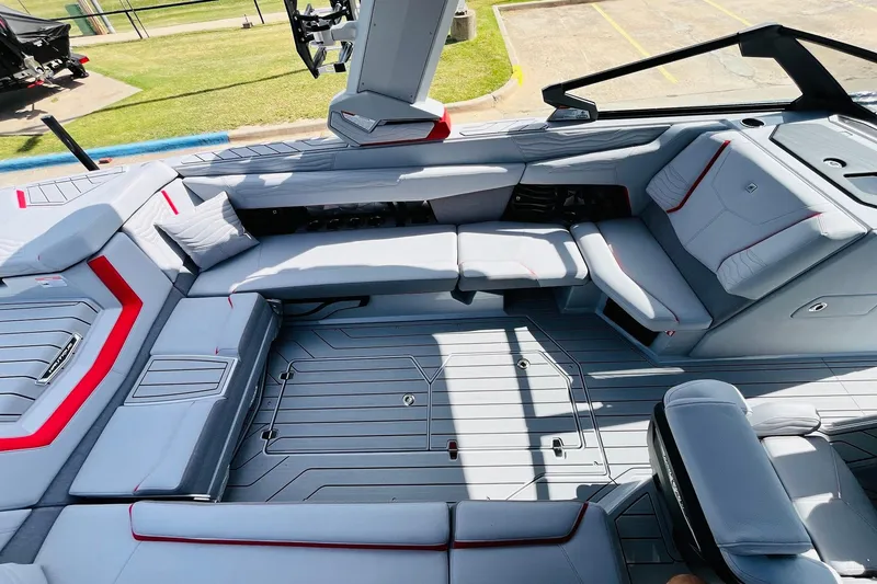 Slide: The Image of 2026 Nautique Super Air Nautique G25 interior with sleek gray seating and red accents. - 39