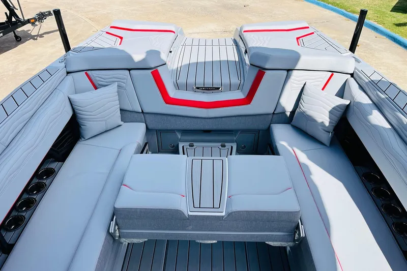 Slide: The Image of 2026 Nautique Super Air Nautique G25 interior with sleek gray seating and red accents. - 45