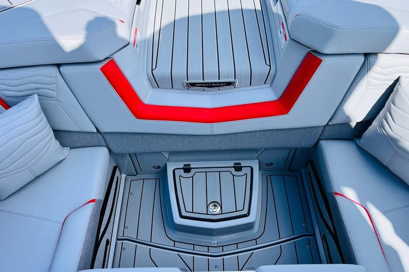 Slide: The Image of 2026 Nautique Super Air Nautique G25 interior with modern seating and red accents. - 49