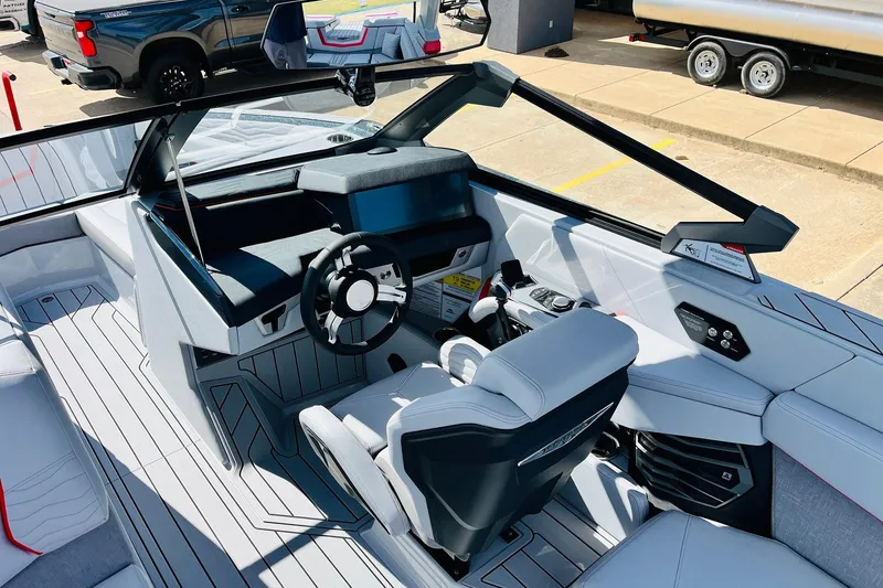 Slide: The Image of 2026 Nautique Super Air Nautique G25 boat interior with modern dashboard and seating. - 57