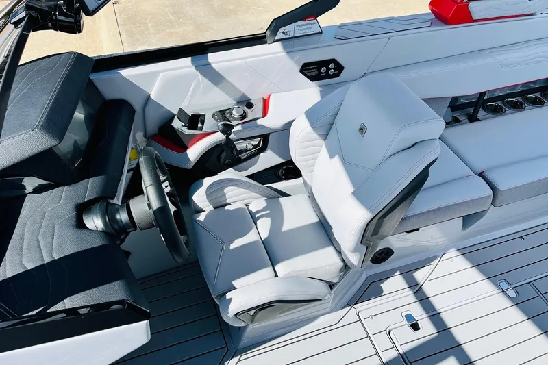 Slide: The Image of Interior of 2026 Nautique Super Air Nautique G25, featuring sleek white seating and modern controls. - 58