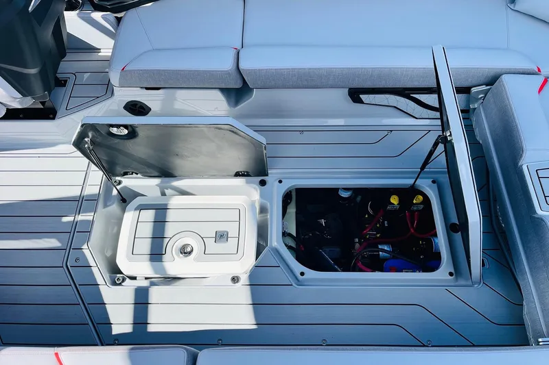 Slide: The Image of 2026 Nautique Super Air Nautique G25 interior storage compartments open on deck. - 64