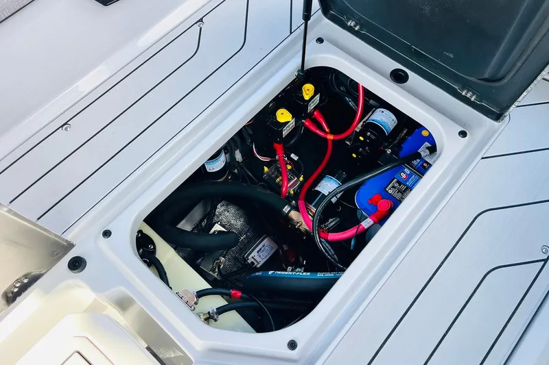 Slide: The Image of Engine compartment of 2026 Nautique Super Air Nautique G25 with visible wiring and components. - 65