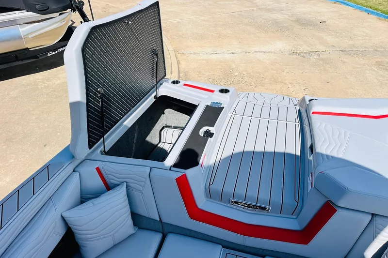 Slide: The Image of 2026 Nautique Super Air Nautique G25 boat interior with open storage compartment. - 71