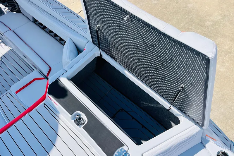 Slide: The Image of Open storage compartment in 2026 Nautique Super Air Nautique G25 boat interior. - 74