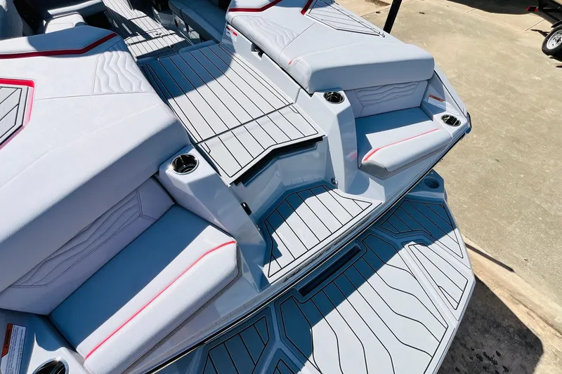 Slide: The Image of 2026 Nautique Super Air Nautique G25 boat interior with sleek seating and cup holders. - 79