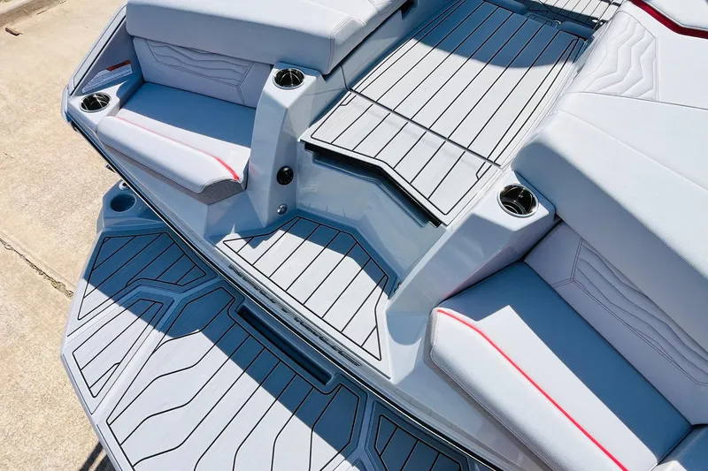 Slide: The Image of 2026 Nautique Super Air Nautique G25 boat interior with sleek seating and cup holders. - 80