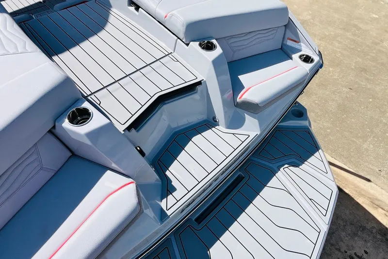 Slide: The Image of 2026 Nautique Super Air Nautique G25 boat deck with seating and cup holders. - 81