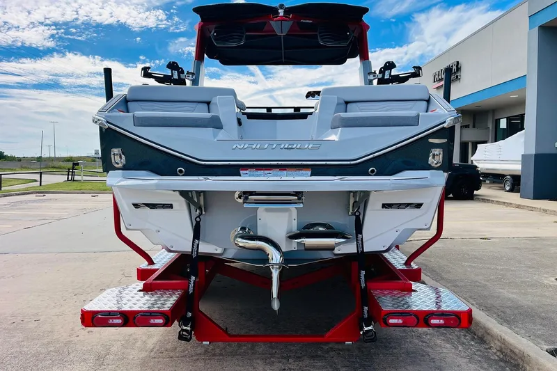Slide: The Image of 2026 Nautique Super Air Nautique G25 boat rear view, parked outdoors. - 9