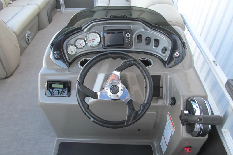 Slide: The Image of 2022 Sun Tracker Party Barge 20 DLX dashboard with steering wheel and controls. - 6