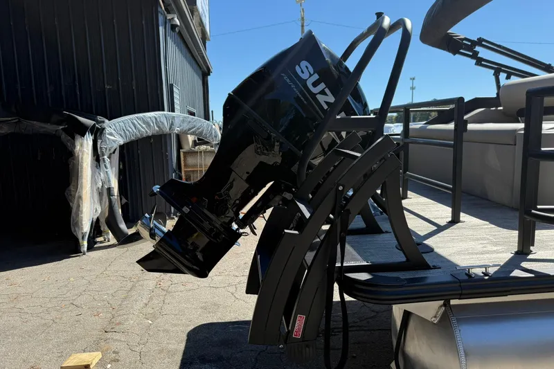 Slide: The Image of 2026 Bentley Pontoons Legacy 223 Swingback with Suzuki outboard motor, docked outdoors. - 3