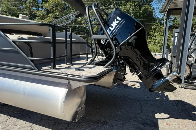 Slide: The Image of 2026 Bentley Pontoons Legacy 223 Swingback with Suzuki outboard motor, docked outdoors. - 5