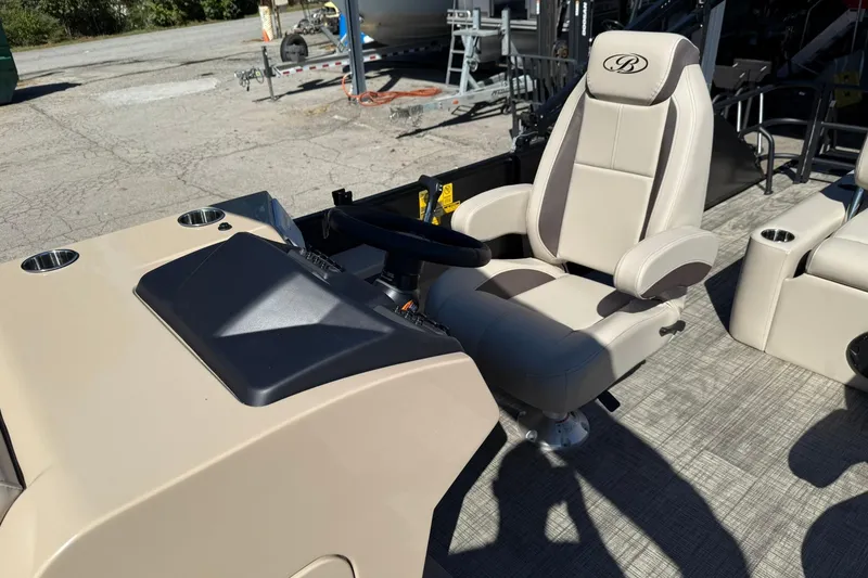 Slide: The Image of 2026 Bentley Pontoons Legacy 223 Swingback captain's chair and helm, featuring luxurious design. - 6