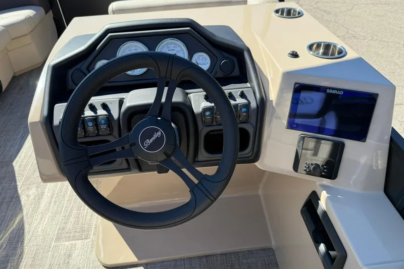Slide: The Image of 2026 Bentley Pontoons Legacy 223 Swingback dashboard with steering wheel and control panel. - 7