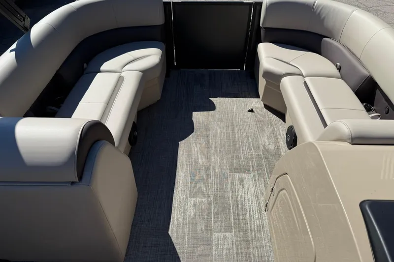 Slide: The Image of 2026 Bentley Pontoons Legacy 223 Swingback interior with beige seating and wood-style flooring. - 9