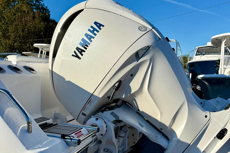 Slide: The Image of 2026 Tidewater 282 CC Adventure boat with Yamaha outboard motor in a marina setting. - 11