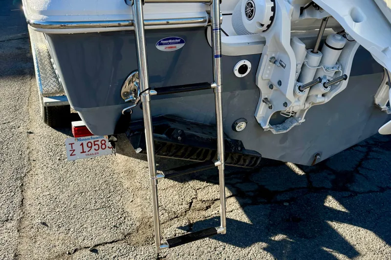 Slide: The Image of Rear view of 2026 Tidewater 282 CC Adventure boat with ladder and Massachusetts trailer plate. - 16
