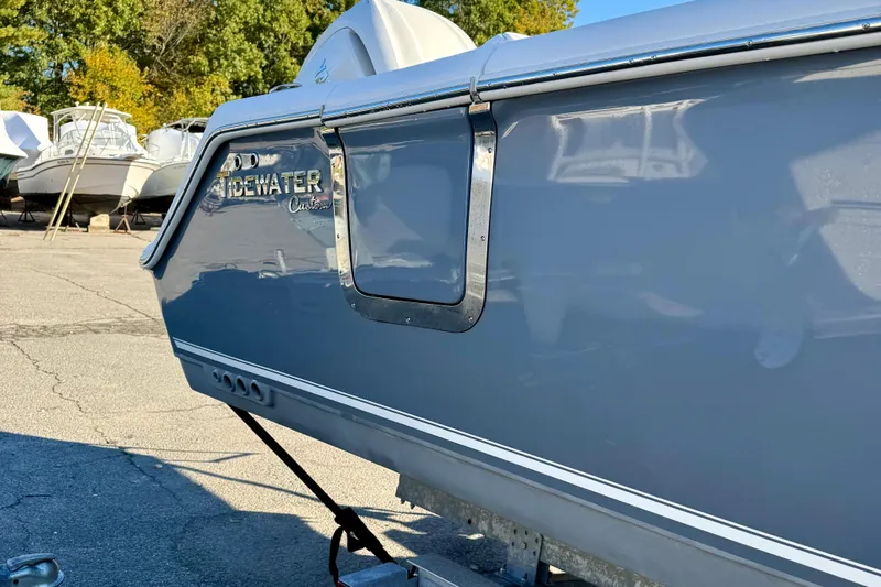 Slide: The Image of 2026 Tidewater 282 CC Adventure boat in a marina, side view. - 17