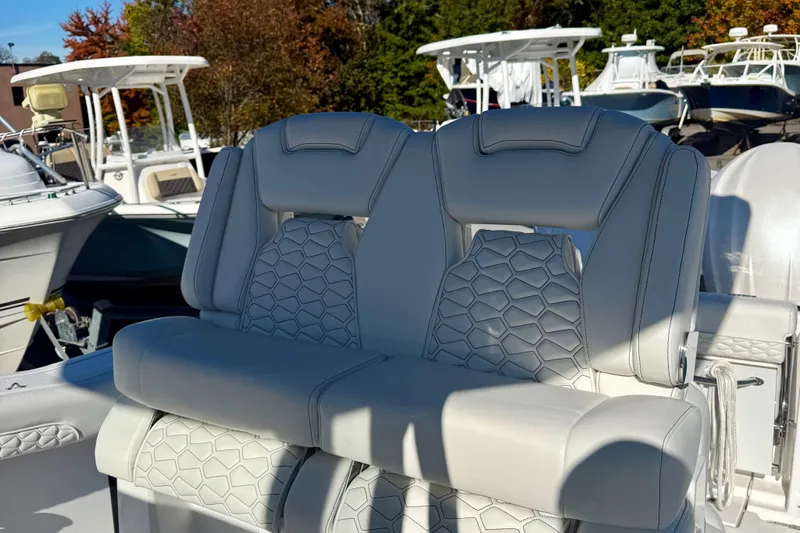Slide: The Image of 2026 Tidewater 282 CC Adventure boat seats with modern design and stitching detail. - 20