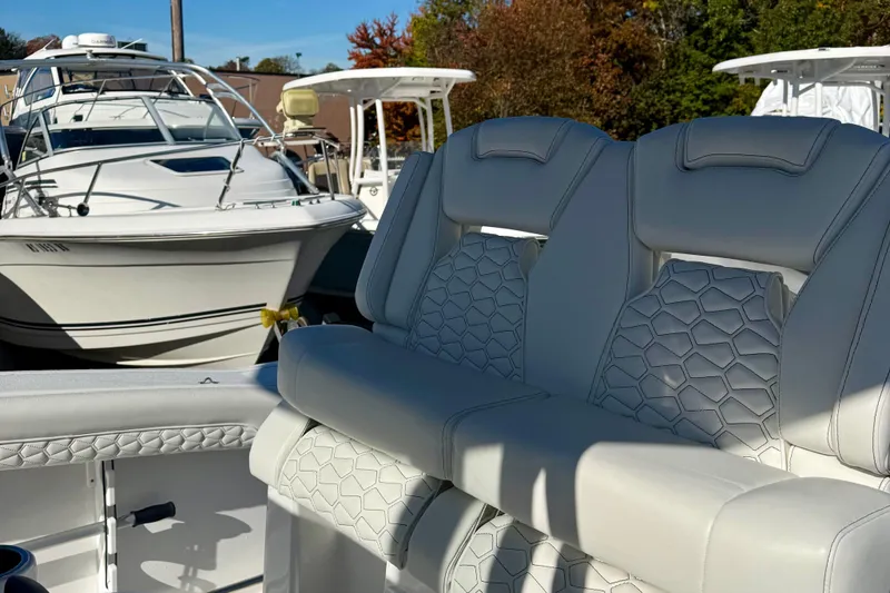 Slide: The Image of 2026 Tidewater 282 CC Adventure boat with luxurious seating, docked alongside other vessels. - 21