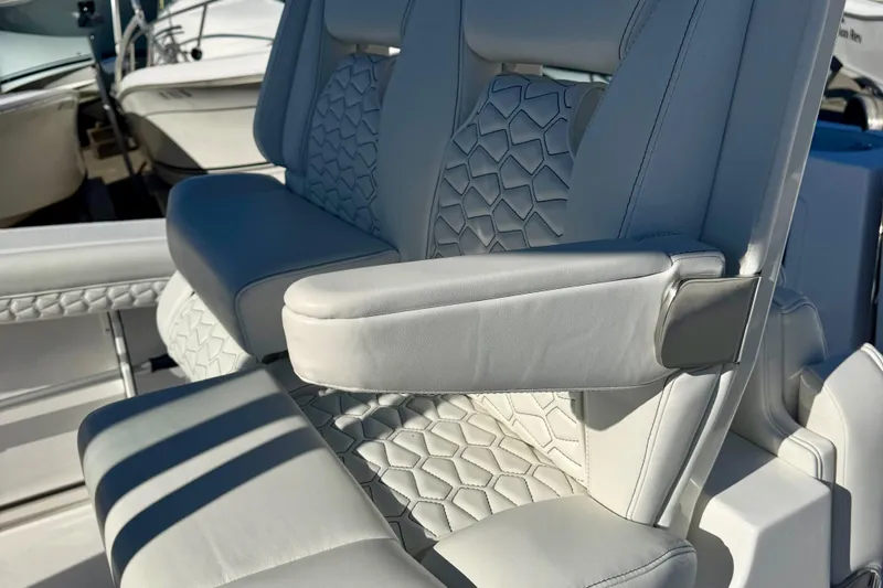 Slide: The Image of 2026 Tidewater 282 CC Adventure boat seats with elegant white upholstery and armrests. - 23