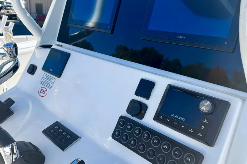Slide: The Image of Control panel of 2026 Tidewater 282 CC Adventure boat with Garmin and JL Audio systems. - 28