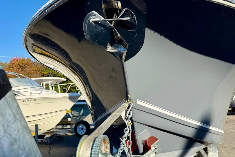 Slide: The Image of 2026 Tidewater 282 CC Adventure boat bow with anchor, parked on trailer. - 4