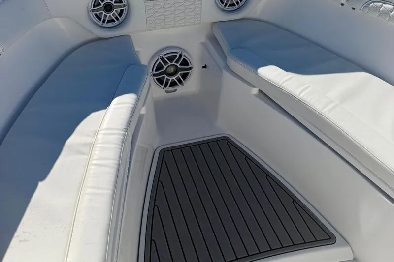 Slide: The Image of 2026 Tidewater 282 CC Adventure boat interior with cushioned seating and marine speakers. - 44