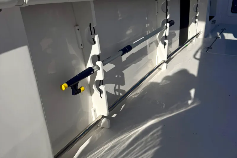 Slide: The Image of 2026 Tidewater 282 CC Adventure boat interior with fishing rod holders. - 49