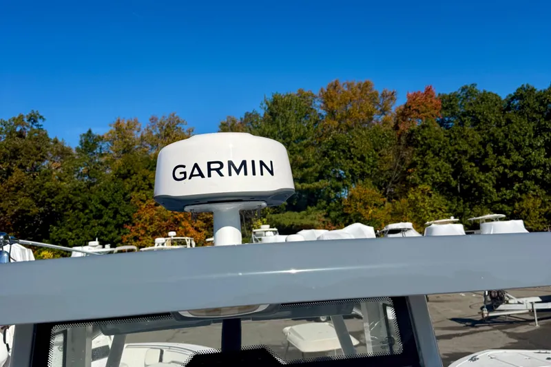 Slide: The Image of Garmin radar on 2026 Tidewater 282 CC Adventure boat, surrounded by trees. - 56