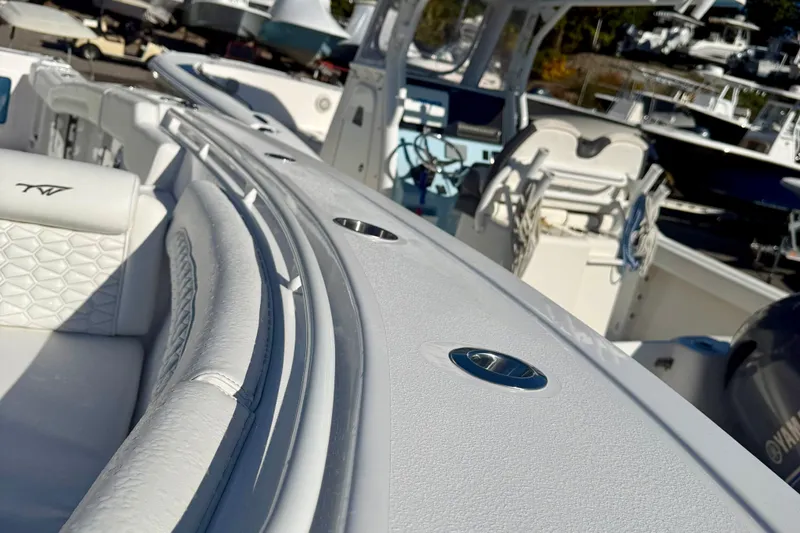 Slide: The Image of 2026 Tidewater 282 CC Adventure boat interior with white seating and sleek design. - 57