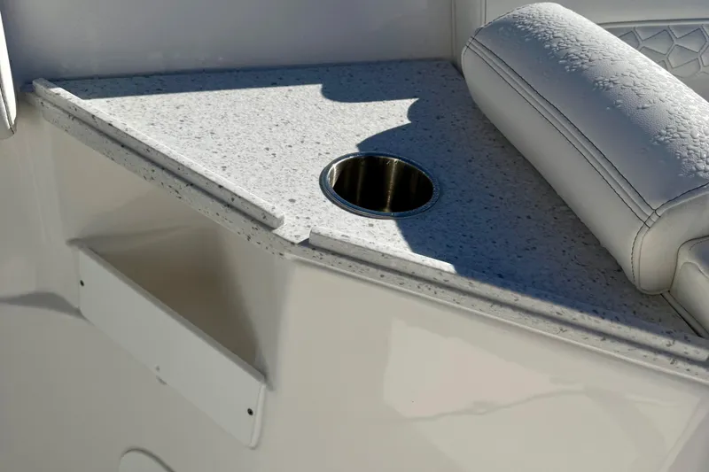 Slide: The Image of 2026 Tidewater 282 CC Adventure boat interior with cup holder and cushioned seating. - 58