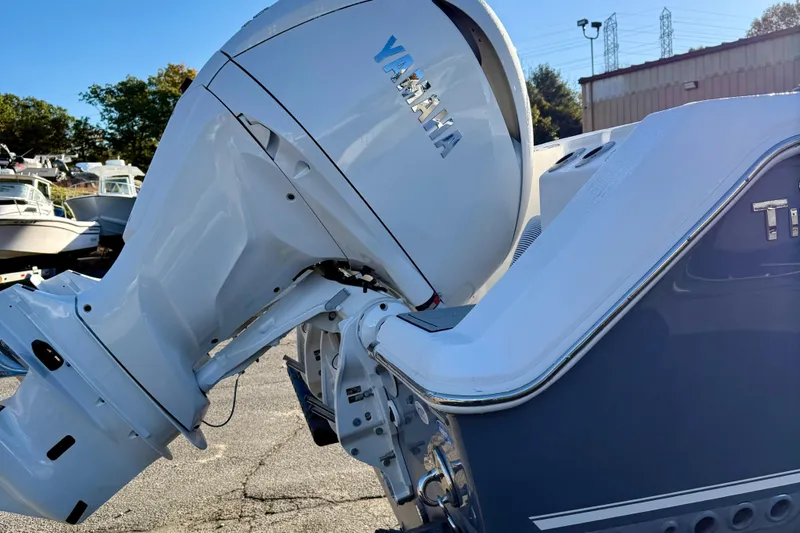 Slide: The Image of 2026 Tidewater 282 CC Adventure boat with Yamaha outboard engine in a marina setting. - 6